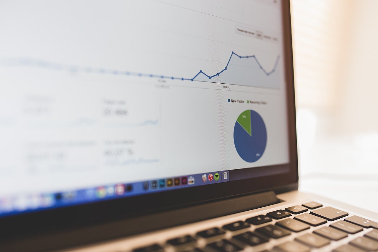 Laptop screen showing analytics line and pie charts