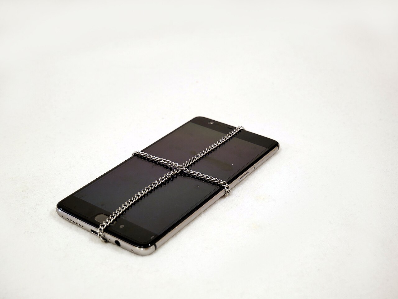 Smartphone wrapped in a chain with a padlock